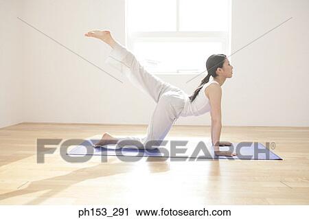 Side profile of a young woman exercising View Large Photo Image Stock Image - Side profile of a young woman exercising. Fotosearch