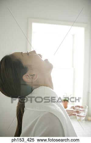 Side profile of a young woman gargling View Large Photo Image Stock Photography - Side profile of a young woman gargling. Fotosearch