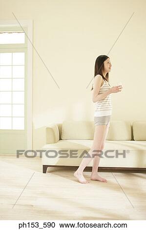 Side profile of a young woman holding a glass of water and smiling View Large Photo Image Stock Image - Side profile of a young woman holding a glass of water and smiling. Fotosearch