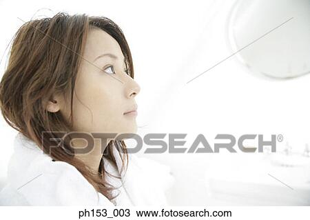 Side profile of a young woman looking into a mirror View Large Photo Image Stock Image - Side profile of a young woman looking into a mirror. Fotosearch