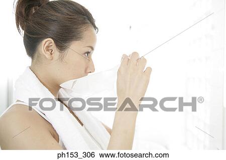 Side profile of a young woman removing facial mask from her face View Large Photo Image Stock Photograph - Side profile of a young woman removing facial mask from her face. Fotosearch