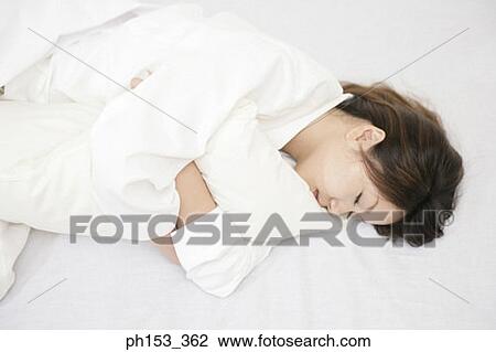 Side profile of a young woman sleeping with a pillow View Large Photo Image Stock Image - Side profile of a young woman sleeping with a pillow. Fotosearch