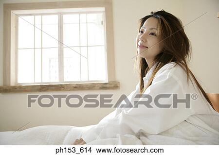 Side profile of a young woman smiling View Large Photo Image Picture - Side profile of a young woman smiling. Fotosearch