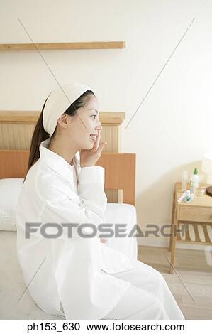 Side profile of a young woman smiling View Large Photo Image Stock Image - Side profile of a young woman smiling. Fotosearch
