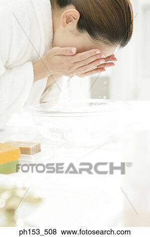 Side profile of a young woman washing her face View Large Photo Image Stock Photo - Side profile of a young woman washing her face. Fotosearch
