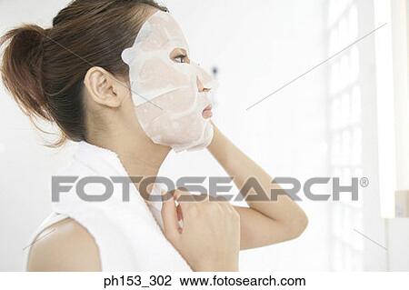 Side profile of a young woman with paper facial mask on her face View Large Photo Image Stock Image - Side profile of a young woman with paper facial mask on her face. Fotosearch