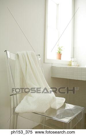 Towel on a chair in the bathroom View Large Photo Image Stock Photography - Towel on a chair in the bathroom. Fotosearch