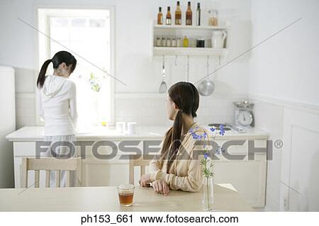 Stock Image - Two young women in the kitchen. Fotosearch