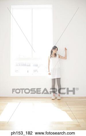 Young woman holding a tape measure View Large Photo Image Stock Image - Young woman holding a tape measure. Fotosearch