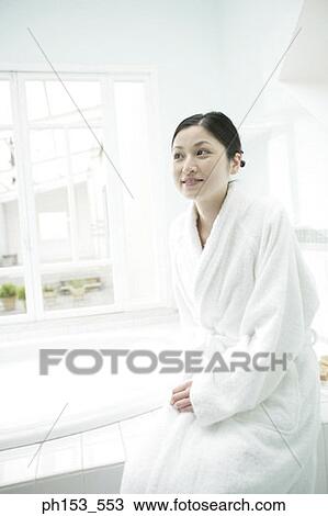 Young woman sitting near a bathtub View Large Photo Image Stock Image - Young woman sitting near a bathtub. Fotosearch