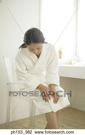 Young woman sitting on a chair in the bathroom View Large Photo Image Stock Image - Young woman sitting on a chair in the bathroom. Fotosearch