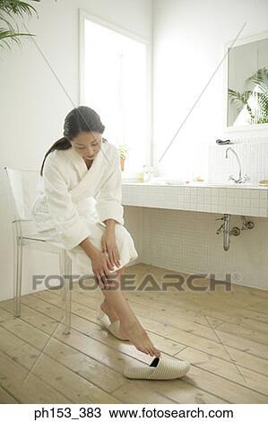 Young woman sitting on a chair in the bathroom View Large Photo Image Stock Image - Young woman sitting on a chair in the bathroom. Fotosearch