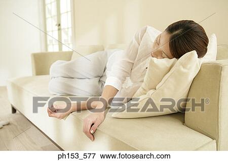 Young woman sleeping on a couch View Large Photo Image Stock Photo - Young woman sleeping on a couch. Fotosearch