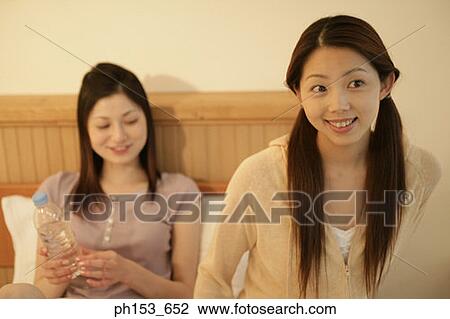 Young woman smiling with her sister View Large Photo Image Stock Image - Young woman smiling with her sister. Fotosearch