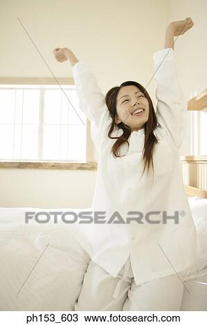 Young woman stretching her arms View Large Photo Image Stock Image - Young woman stretching her arms. Fotosearch
