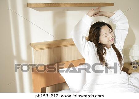 Young woman stretching her arms View Large Photo Image Stock Image - Young woman stretching her arms. Fotosearch