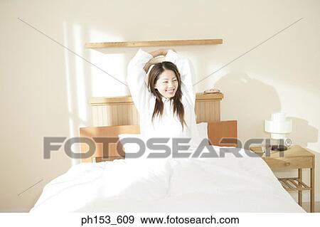 Young woman stretching her arms View Large Photo Image Stock Photo - Young woman stretching her arms. Fotosearch