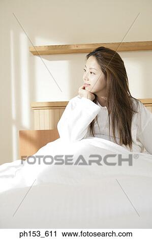 Young woman thinking with her hand on her chin View Large Photo Image Stock Image - Young woman thinking with her hand on her chin. Fotosearch