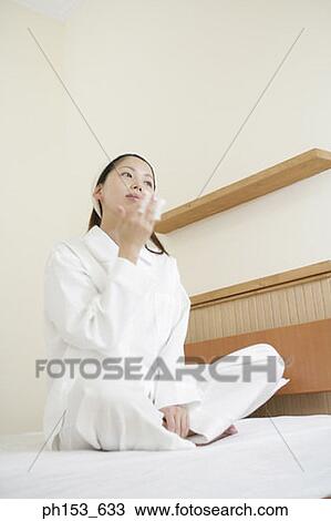 Young woman wiping her face with a handkerchief View Large Photo Image Stock Image - Young woman wiping her face with a handkerchief. Fotosearch