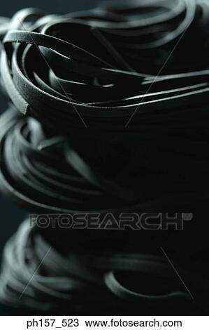 Stock Image - Black noodles, close-up. Fotosearch