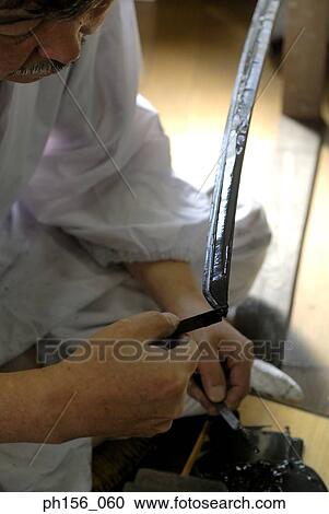 Blacksmith applying a coating of chrome on a sword View Large Photo Image Stock Image - Blacksmith applying a coating of chrome on a sword. Fotosearch