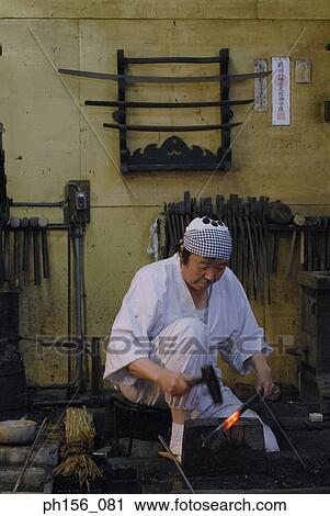 Blacksmith hitting a heated metal rod with a hammer View Large Photo Image Stock Image - Blacksmith hitting a heated metal rod with a hammer. Fotosearch