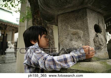 Boy looking in a birdhouse View Large Photo Image Stock Photography - Boy looking in a birdhouse. Fotosearch