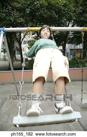 Boy playing on a swing View Large Photo Image Stock Image - Boy playing on a swing. Fotosearch