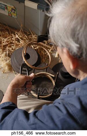 Carpenter bending a wooden strip with a pair of pliers View Large Photo Image Stock Photograph - Carpenter bending a wooden strip with a pair of pliers. Fotosearch