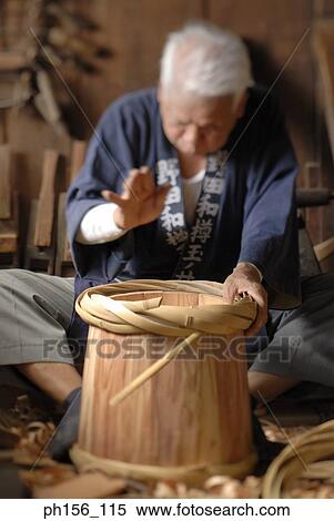Carpenter fixing cane on a barrel View Large Photo Image Stock Photography - Carpenter fixing cane on a barrel. Fotosearch