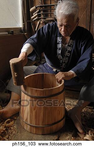 Carpenter hitting a barrel with a mallet View Large Photo Image Stock Image - Carpenter hitting a barrel with a mallet . Fotosearch