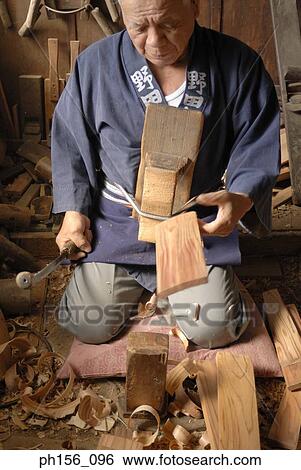 Stock Photograph - Carpenter working in a workshop. Fotosearch