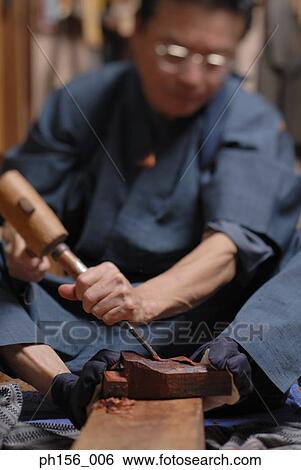Carpenter working with a chisel View Large Photo Image Stock Photograph - Carpenter working with a chisel. Fotosearch
