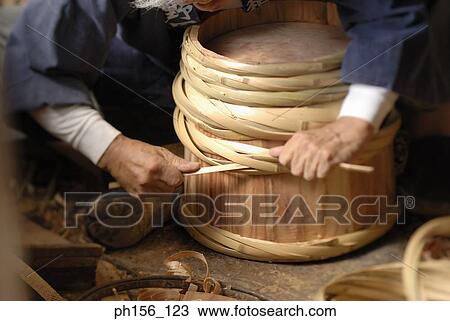 Close-up of a barrel and human hand View Large Photo Image Stock Image - Close-up of a barrel and human hand. Fotosearch