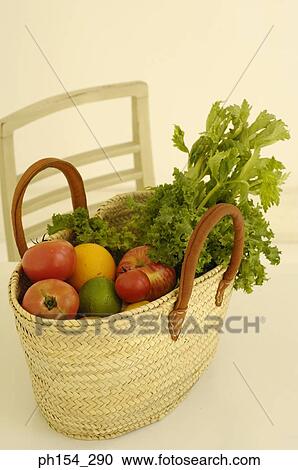 Close-up of a basket with fruits and vegetables on the table View Large Photo Image Stock Image - Close-up of a basket with fruits and vegetables on the table. Fotosearch