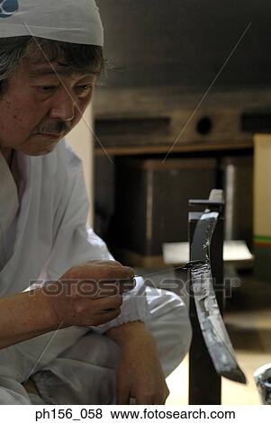 Close-up of a blacksmith applying a coating of chrome on a sword View Large Photo Image Stock Photo - Close-up of a blacksmith applying a coating of chrome on a sword. Fotosearch