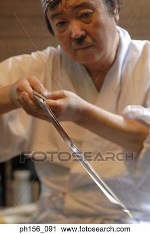 Close-up of a blacksmith examining a sword View Large Photo Image Stock Image - Close-up of a blacksmith examining a sword. Fotosearch