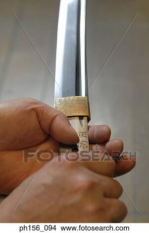 Picture - Close-up of a blacksmith's hand holding a sword. Fotosearch