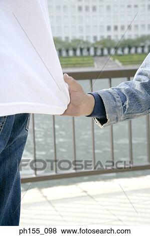 Close-up of a boy's hand pulling a person's t-shirt View Large Photo Image Stock Photo - Close-up of a boy's hand pulling a person's t-shirt. Fotosearch