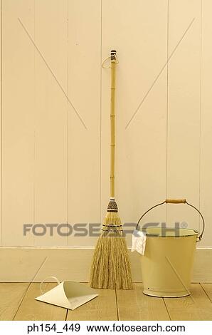Close-up of a broom stick and a dustpan near a bucket View Large Photo Image Stock Photo - Close-up of a broom stick and a dustpan near a bucket. Fotosearch