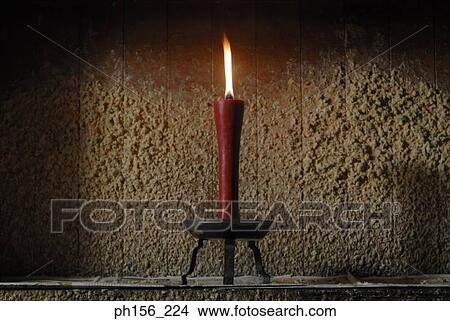 Close-up of a burning candle in a workshop View Large Photo Image Picture - Close-up of a burning candle in a workshop. Fotosearch
