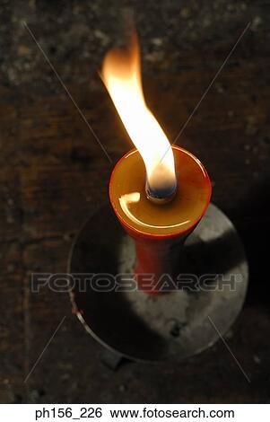 Close-up of a burning candle View Large Photo Image Stock Photograph - Close-up of a burning candle. Fotosearch