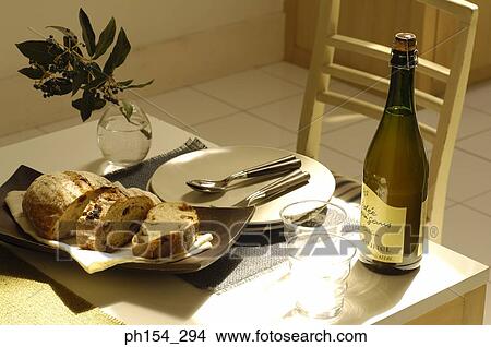 Close-up of a cake and a wine bottle with glasses on the dining table View Large Photo Image Picture - Close-up of a cake and a wine bottle with glasses on the dining table. Fotosearch