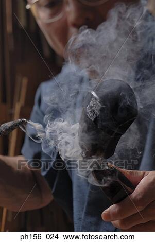 Close-up of a carpenter holding a hot rod View Large Photo Image Picture - Close-up of a carpenter holding a hot rod. Fotosearch