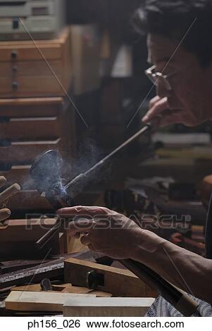 Close-up of a carpenter working with a hot rod View Large Photo Image Stock Photograph - Close-up of a carpenter working with a hot rod. Fotosearch