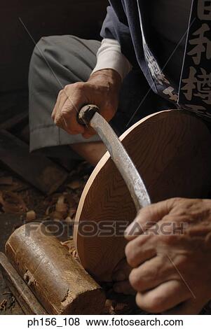 Close-up of a carpenter's hand shaping the edge of a circular piece of wood View Large Photo Image Stock Photo - Close-up of a carpenter's hand shaping the edge of a circular piece of wood. Fotosearch