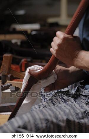 Close-up of a carpenter's hand working on a wooden stick View Large Photo Image Picture - Close-up of a carpenter's hand working on a wooden stick. Fotosearch