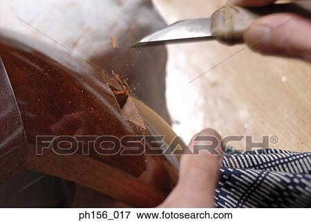 Stock Photo - Close-up of a carpenter's hand working with a chisel. Fotosearch