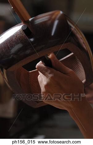 Stock Photography - Close-up of a carpenter's hand working on a wooden structure. Fotosearch