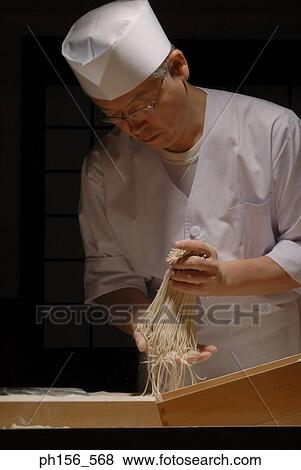 Close-up of a chef applying flour on raw noodles View Large Photo Image Stock Photo - Close-up of a chef applying flour on raw noodles. Fotosearch